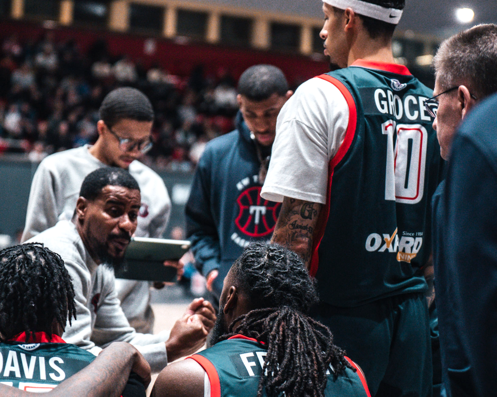 Coaches Cliff Clinkscales and James Robinson take a time out to regroup the KW Titans for a furious push in the final-quarter of the game.